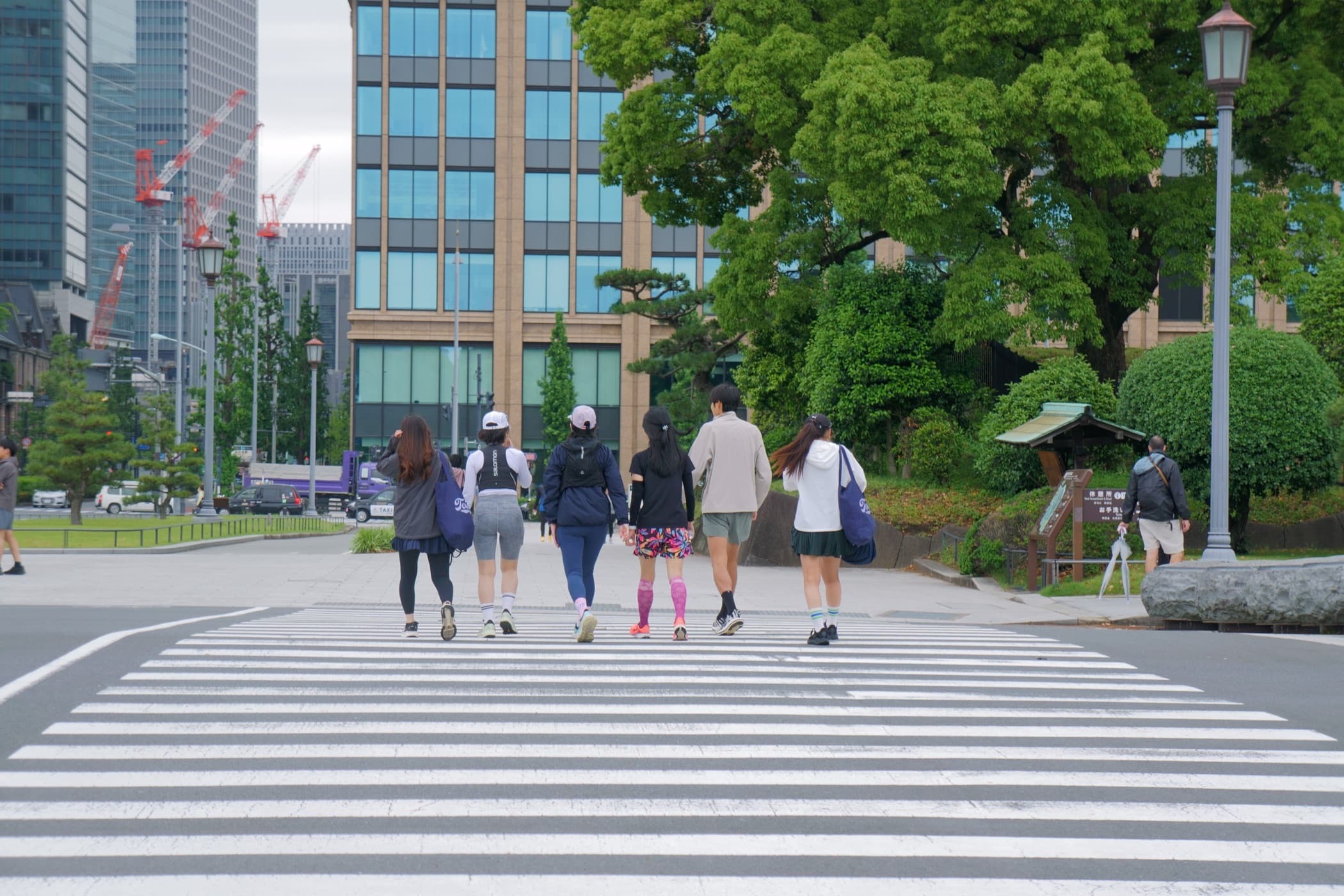 Small group crossing from park into the city